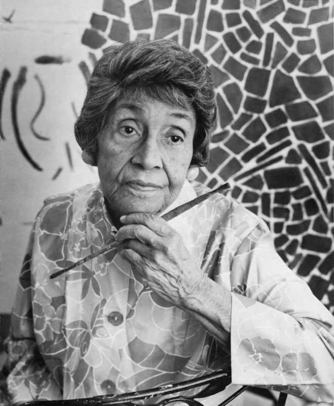 Black and white photo of Alma Thomas, an elderly Black woman, holding a paintbrush