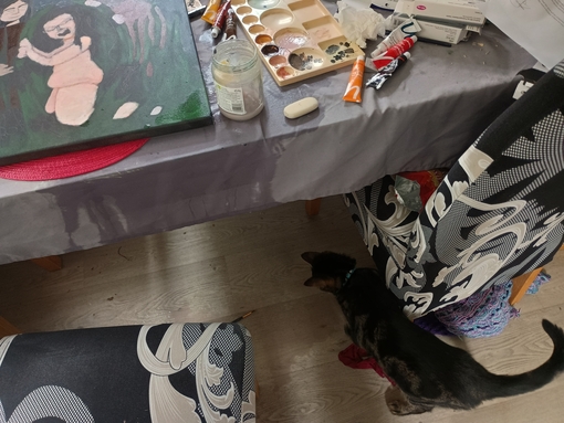 A partial view of my painting, on a table with a wet patch and a pool of water on the floor