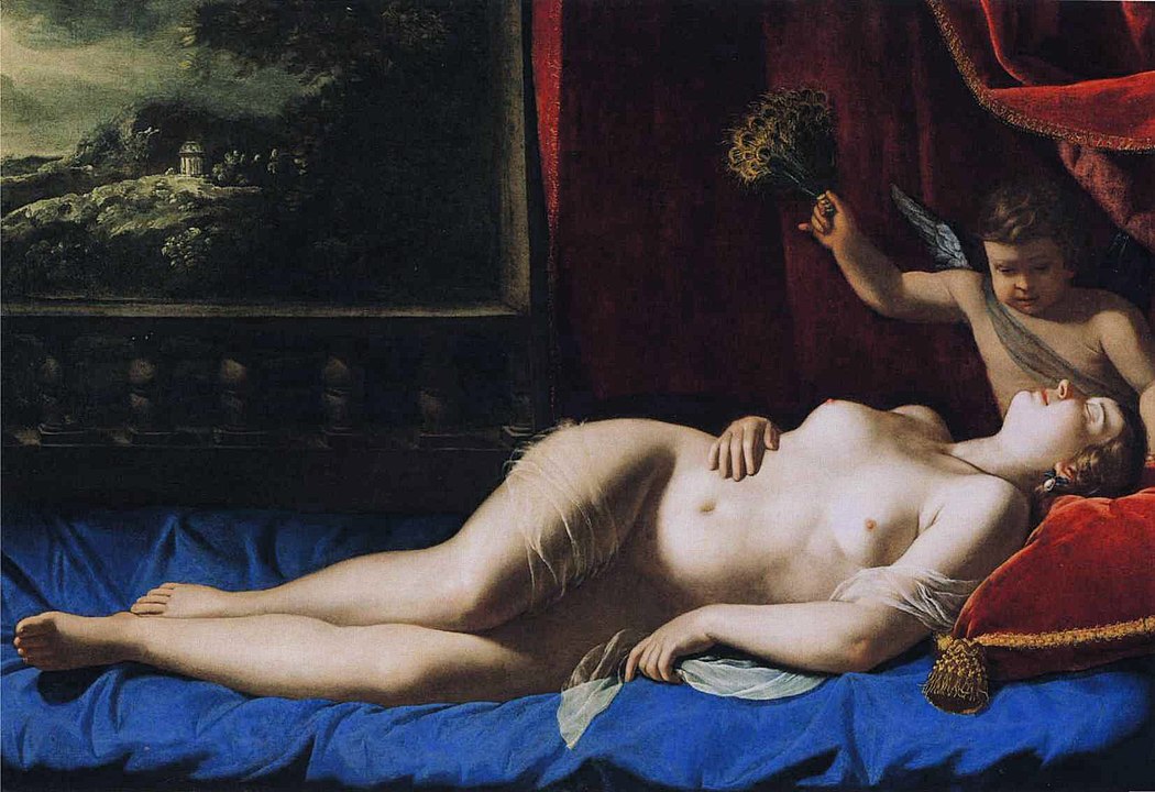 A naked woman, Venus, is lying on a bed adorned with blue sheets being attended to by her son Cupid, red curtains surrond the bed and there is a landcape painting in the background