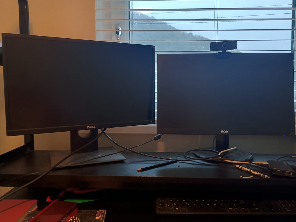 Photo of two monitor on black desk