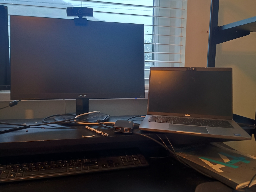 Photo of monitor and laptop on black desk