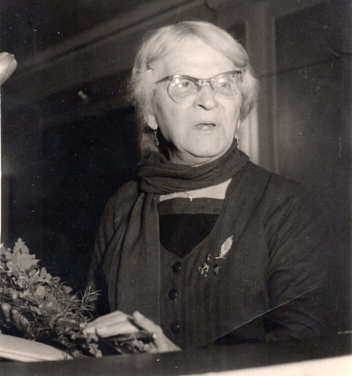 Photo of a white woman in her 50s/60s with large glasses