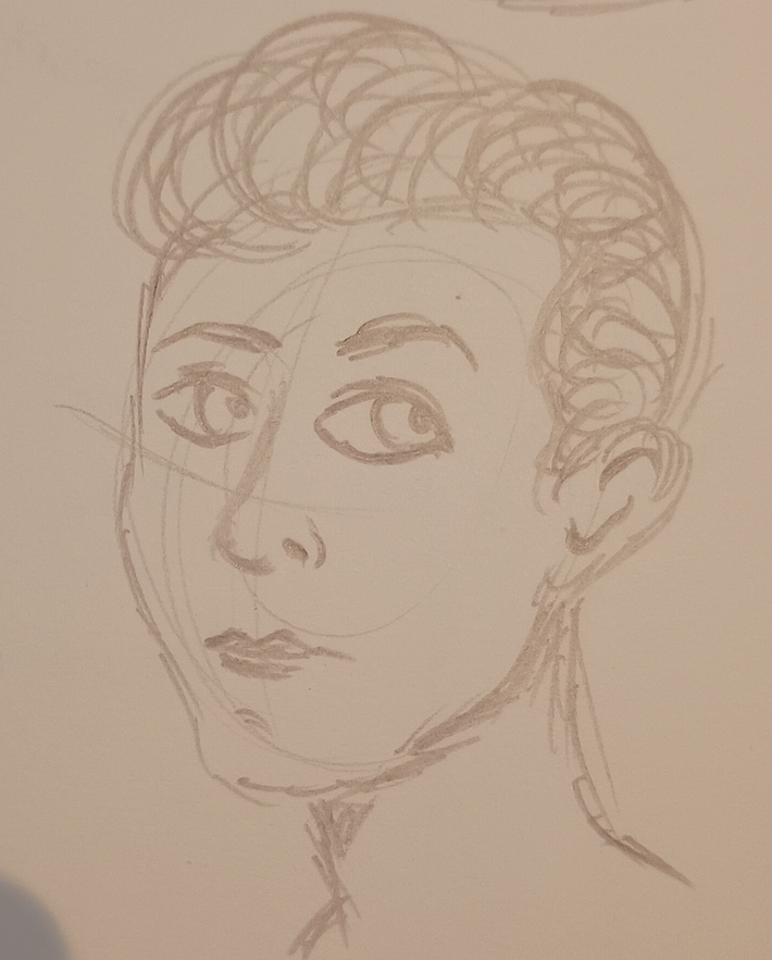 A man with slicked back hair and thick lips in profile